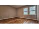 Bedroom with wood floors, two windows for natural light, and neutral walls at 1325 Classic Ne Dr, Conyers, GA 30013
