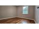 Bedroom featuring warm hardwood floors, neutral walls, and a window at 1325 Classic Ne Dr, Conyers, GA 30013
