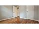 Bedroom with warm hardwood floors, neutral walls, closet and doorway at 1325 Classic Ne Dr, Conyers, GA 30013