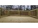 View of the wooden deck with railings surrounded by trees, a great place for outdoor relaxation at 1325 Classic Ne Dr, Conyers, GA 30013