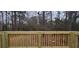 Wooden deck with railings overlooks backyard with views of wooded area at 1325 Classic Ne Dr, Conyers, GA 30013