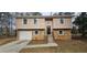 Charming two-story home with stone accents, garage, and tidy front yard at 1325 Classic Ne Dr, Conyers, GA 30013