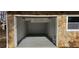 A one-car garage featuring stone siding and a painted interior at 1325 Classic Ne Dr, Conyers, GA 30013