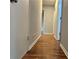Hallway with wood floors leading to other rooms in the home at 1325 Classic Ne Dr, Conyers, GA 30013