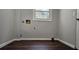 A utility room with laminate wood flooring and hookups for a washer and dryer at 1325 Classic Ne Dr, Conyers, GA 30013