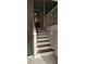 Staircase with wooden stairs, white risers and railing leading to the kitchen at 1325 Classic Ne Dr, Conyers, GA 30013