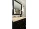 Bathroom featuring a marble vanity top and framed mirror at 2965 Pharr Court South Nw # 316, Atlanta, GA 30305