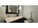 Bathroom featuring a marble vanity top and framed mirror at 2965 Pharr Court South Nw # 316, Atlanta, GA 30305