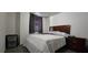 Bedroom featuring a bed, nightstand, and window with blinds at 2965 Pharr Court South Nw # 316, Atlanta, GA 30305