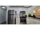 Well-lit modern kitchen features stainless steel appliances and white cabinets at 2965 Pharr Court South Nw # 316, Atlanta, GA 30305