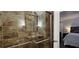 Walk-in shower with stone-look tiles, glass door, and safety bar at 2965 Pharr Court South Nw # 316, Atlanta, GA 30305