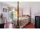Well-lit bedroom featuring a four-poster bed, hardwood floors and neutral-toned walls at 760 Josh Ln, Lawrenceville, GA 30045