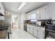 Bright galley kitchen with granite counters, white cabinets and stainless steel appliances at 760 Josh Ln, Lawrenceville, GA 30045