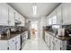 Bright galley kitchen with granite counters, white cabinets and stainless steel appliances at 760 Josh Ln, Lawrenceville, GA 30045