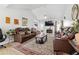 Open living room featuring brown leather furniture, fireplace, and natural light at 760 Josh Ln, Lawrenceville, GA 30045