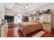 Bright main bedroom featuring a tray ceiling, red flooring, and matching furniture at 760 Josh Ln, Lawrenceville, GA 30045