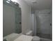 Well-lit bathroom features a shower with white marble-style tile and glass door at 2100 Caneridge Sw Dr, Marietta, GA 30064