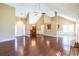 Open floor plan living room with wood floors, vaulted ceilings, and an open view of the kitchen and dining area at 4095 Mark Todd Ct, Hoschton, GA 30548