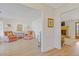 Bright living room with hardwood floors, neutral walls, two armchairs and doorway view to brick fireplace at 2077 Moccasin Sw Way, Marietta, GA 30064