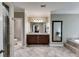 Main bathroom with a dual vanity, tile flooring, and a large soaking tub, providing a relaxing retreat at 2421 Saint Davids Nw Sq, Kennesaw, GA 30152