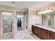 Bathroom view includes a walk-in shower, double sink vanity, and entries to walk-in closet and toilet at 2421 Saint Davids Nw Sq, Kennesaw, GA 30152