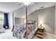 Well-lit bedroom with neutral colors, ceiling fan, and a four-poster bed at 2421 Saint Davids Nw Sq, Kennesaw, GA 30152