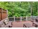 Exterior deck featuring chairs, grill, and peaceful green trees at 2421 Saint Davids Nw Sq, Kennesaw, GA 30152