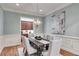 Dining area featuring modern chandelier, light blue walls, and seating for six at 2421 Saint Davids Nw Sq, Kennesaw, GA 30152