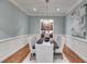 Formal dining room with wainscoting, chandelier, and seating for six at 2421 Saint Davids Nw Sq, Kennesaw, GA 30152