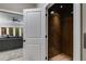 Modern home elevator with wood paneled interior, adjacent to living space with comfortable seating at 2421 Saint Davids Nw Sq, Kennesaw, GA 30152