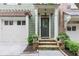 Charming front entrance featuring stone steps, a covered porch, and green shingle siding at 2421 Saint Davids Nw Sq, Kennesaw, GA 30152