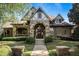Charming home featuring stone and brick facade, manicured lawn, and covered porch at 2421 Saint Davids Nw Sq, Kennesaw, GA 30152