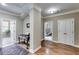 Hallway with hardwood floors, decorative rug, and views into adjacent rooms with natural light at 2421 Saint Davids Nw Sq, Kennesaw, GA 30152