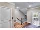 Hallway featuring hardwood floors, staircase, and doorway to a laundry room with natural light at 2421 Saint Davids Nw Sq, Kennesaw, GA 30152