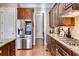 Modern kitchen featuring stainless steel appliances, granite countertops, and wood cabinetry at 2421 Saint Davids Nw Sq, Kennesaw, GA 30152