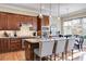 Well-appointed kitchen with island, granite counters, stainless appliances, and breakfast area at 2421 Saint Davids Nw Sq, Kennesaw, GA 30152