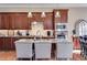 Kitchen island features barstool seating, stainless appliances, and granite countertops at 2421 Saint Davids Nw Sq, Kennesaw, GA 30152