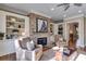 Cozy living room with stone fireplace, built-in shelving, and a comfortable seating arrangement at 2421 Saint Davids Nw Sq, Kennesaw, GA 30152