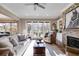 Bright living room with fireplace, built-ins, and doors leading to the outdoor space at 2421 Saint Davids Nw Sq, Kennesaw, GA 30152
