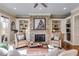 Comfortable living room with stone fireplace, built-in shelving, and ample natural light at 2421 Saint Davids Nw Sq, Kennesaw, GA 30152