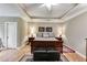 Main bedroom with a tray ceiling, neutral walls, and a dark wood bed with an upholstered bench at 2421 Saint Davids Nw Sq, Kennesaw, GA 30152