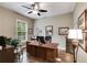 Spacious home office with hardwood floors, a large desk, and ample natural light from the window at 2421 Saint Davids Nw Sq, Kennesaw, GA 30152