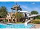 Community swimming pool with a waterslide and surrounding lounge chairs at 2421 Saint Davids Nw Sq, Kennesaw, GA 30152