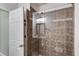 Tiled walk-in shower featuring a glass door and accessible hand rails at 2421 Saint Davids Nw Sq, Kennesaw, GA 30152