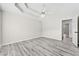 A spacious bedroom features gray wood-look flooring and a modern ceiling fan at 306 Jacob Trl, Rockmart, GA 30153