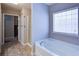 This bright bathroom has a soaking tub and a glass walk-in shower at 3480 Buffington Ln, Cumming, GA 30040