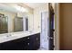 Bathroom with double vanity, dark cabinets, and a large mirror at 3480 Buffington Ln, Cumming, GA 30040