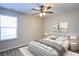 This stylish bedroom has a large window, decorative artwork and a comfortable queen bed at 3480 Buffington Ln, Cumming, GA 30040