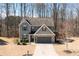 Inviting two-story home featuring a stone-accented garage and a neatly kept front yard at 3480 Buffington Ln, Cumming, GA 30040