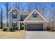 Charming two-story home with a stone-accented garage and well-manicured landscaping at 3480 Buffington Ln, Cumming, GA 30040